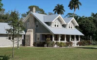 brown and white concrete house near green grass field during daytime