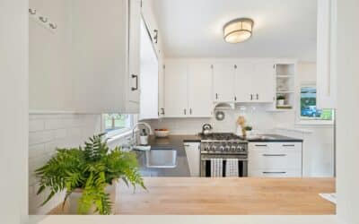 white wooden kitchen cupboards and gray gas stove