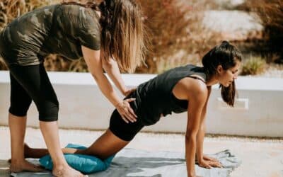 woman in black tank top and black shorts kneeling on mat