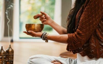 woman in brown knit sweater holding brown ceramic cup