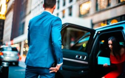 man wearing blue suit standing beside vehicle