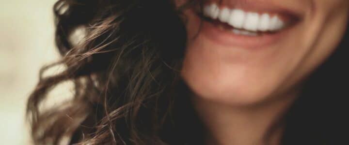 long black haired woman smiling close-up photography